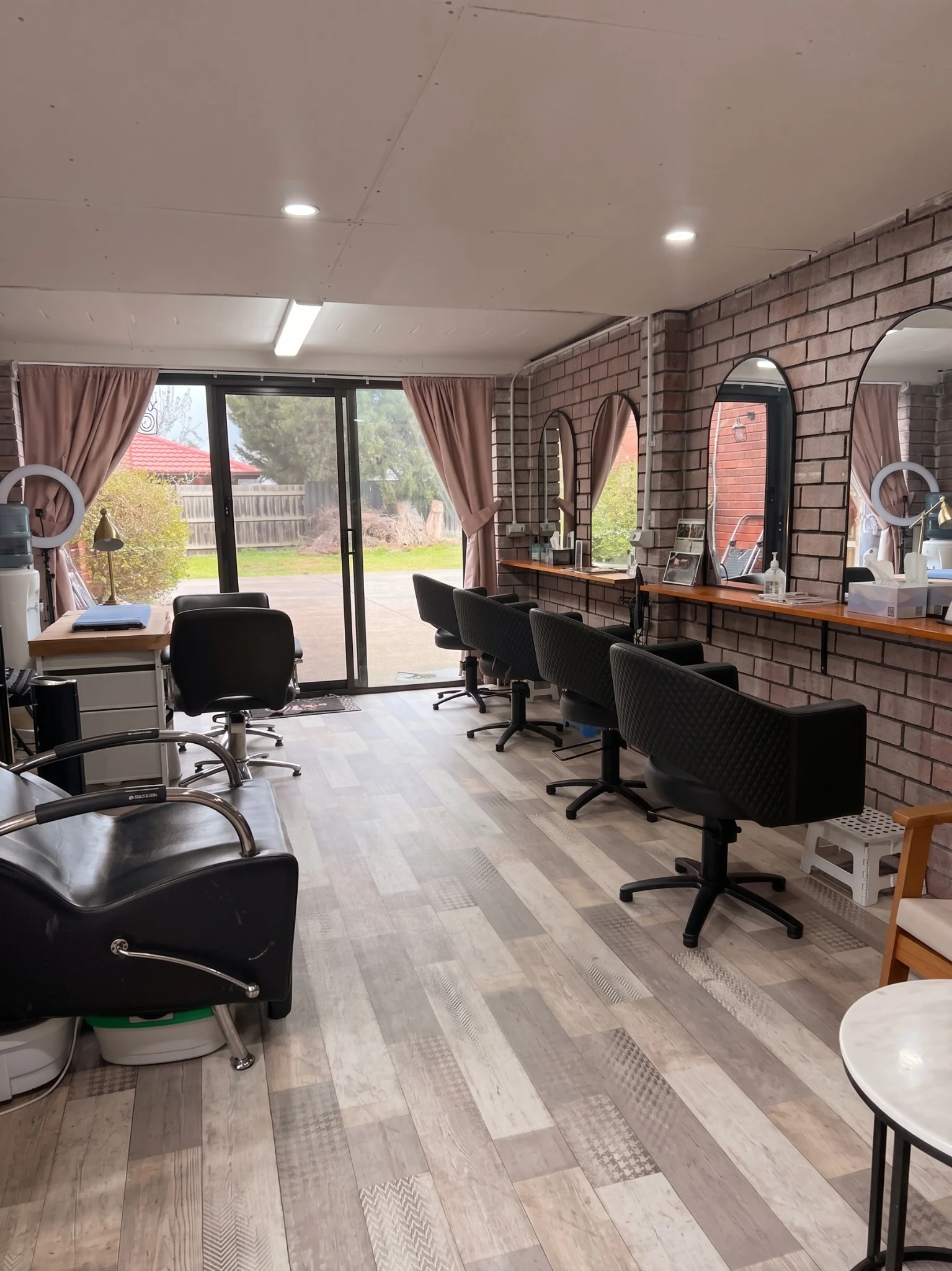 Salon workstations and mirrors inside Naida's Hair Salon